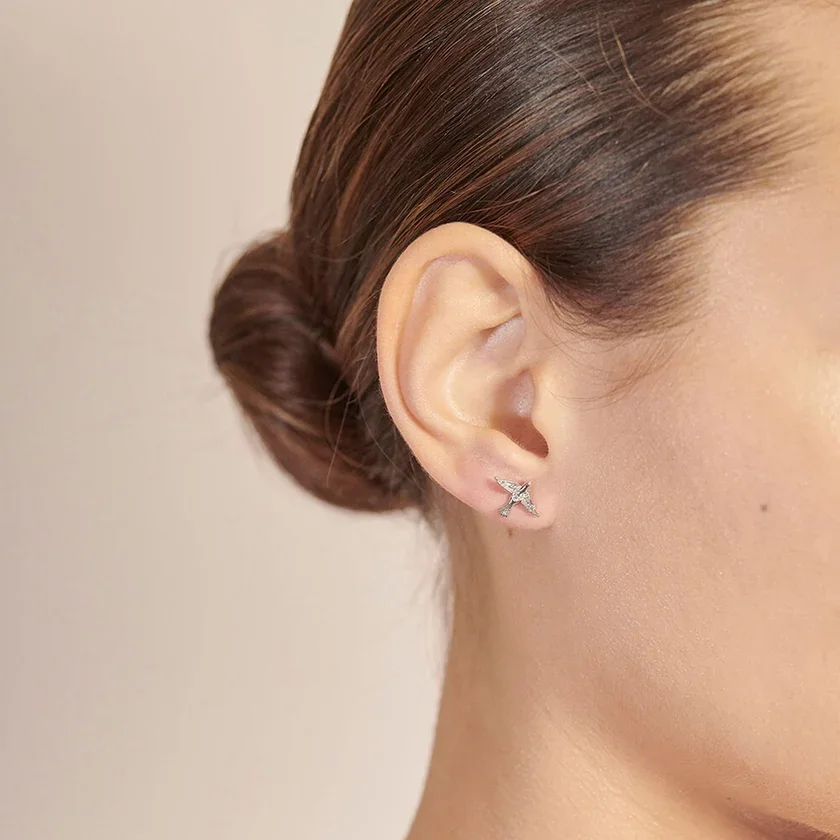 bird earrings in silver in ear