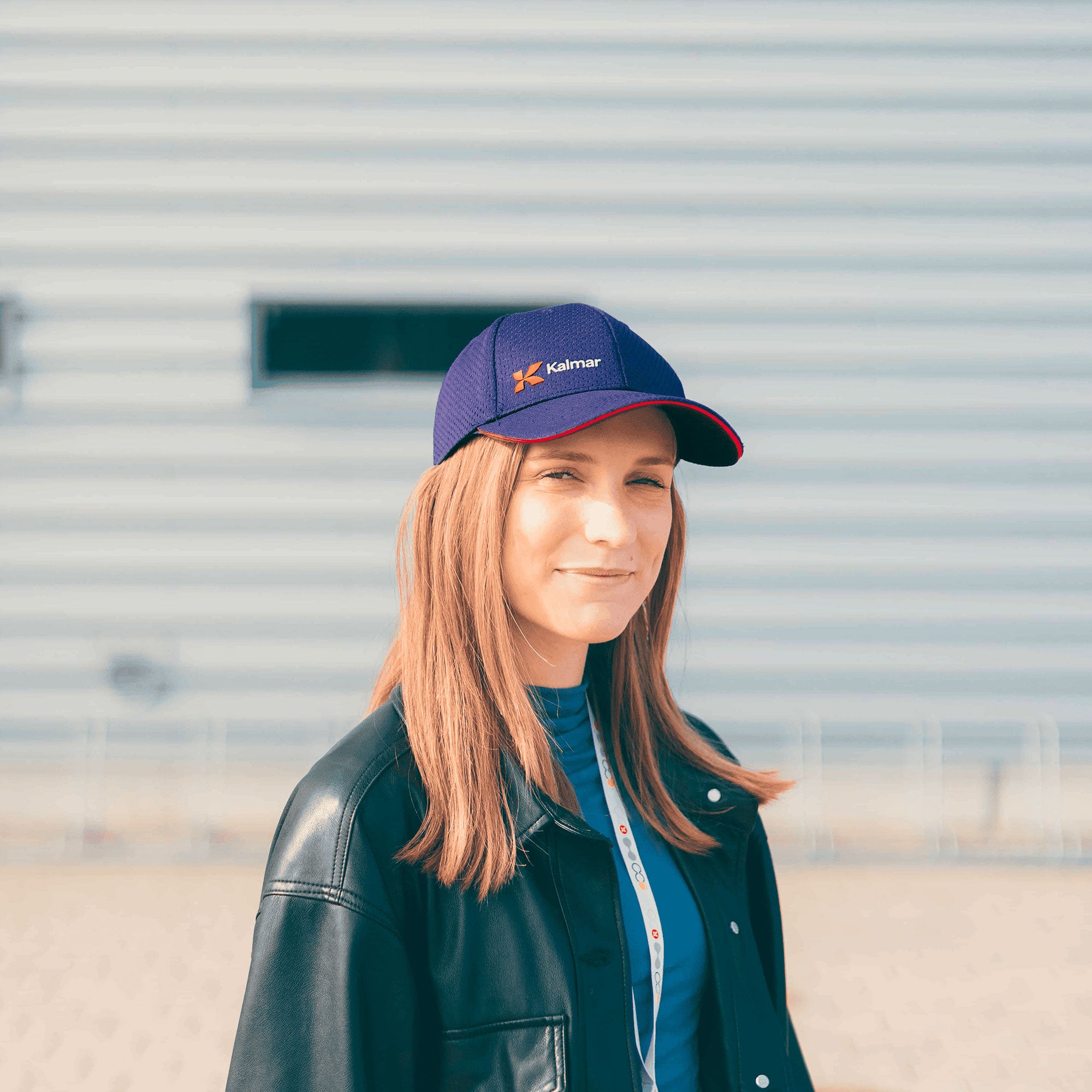 purple kalmar cap with white kalmar logo and red details